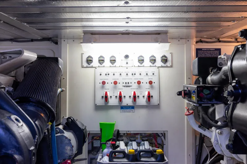 Slide: The Image of Engine room of 2012 Cabo 44 Hardtop Express with Caterpillar components and control panel. - 62