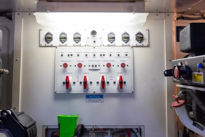 Slide: The Image of Engine room of 2012 Cabo 44 Hardtop Express, featuring control panel and machinery. - 63