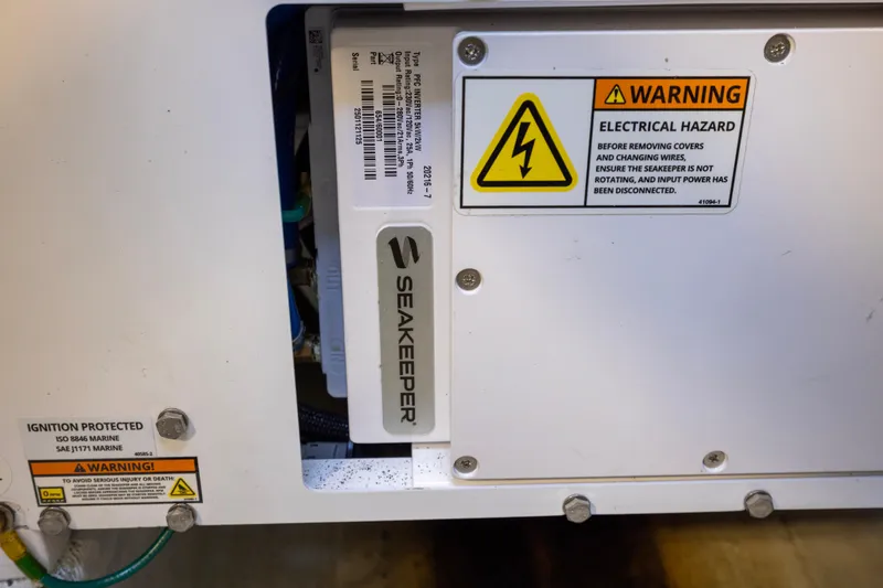 Slide: The Image of Electrical control panel inside 2012 Cabo 44 Hardtop Express boat engine room. - 64