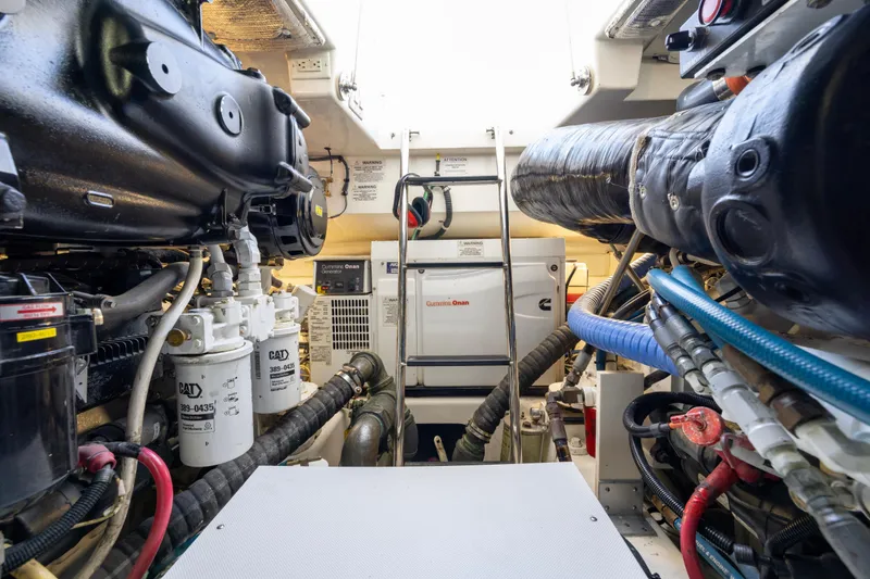Slide: The Image of Engine room of 2012 Cabo 44 Hardtop Express with Cummins Onan generator and ladder. - 67
