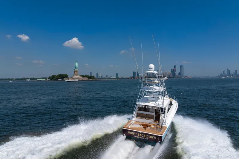 Slide: The Image of 2012 Cabo 44 Hardtop Express yacht cruising near Statue of Liberty, New York City skyline. - 7