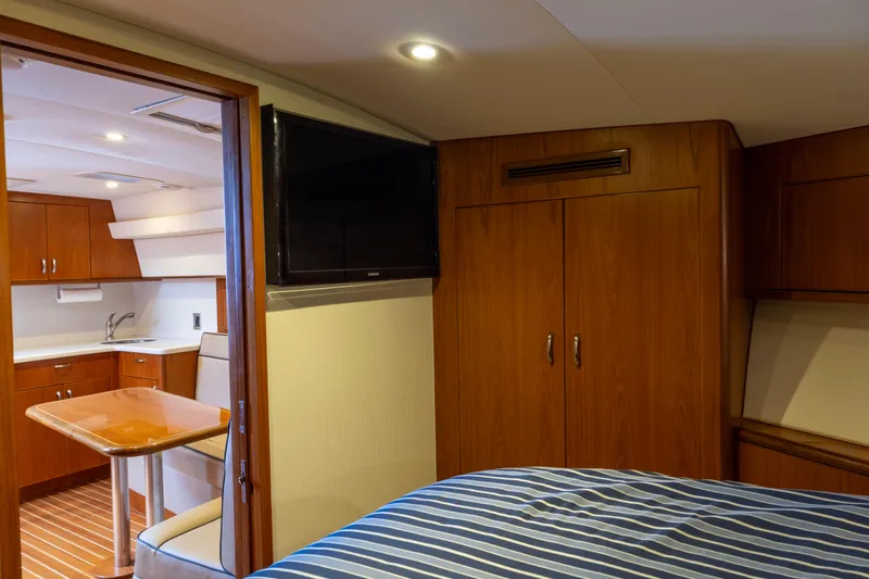 Slide: The Image of Luxurious interior of 2012 Cabo 44 Hardtop Express yacht with bedroom and kitchenette. - 75