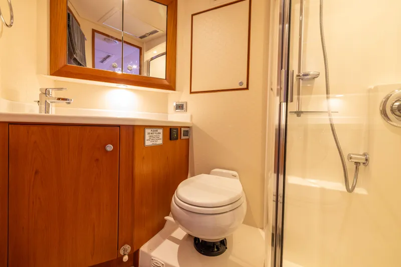 Slide: The Image of Interior of 2012 Cabo 44 Hardtop Express yacht with shower and dining area. - 77