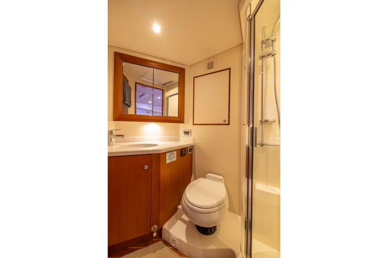 Slide: The Image of 2012 Cabo 44 Hardtop Express yacht bathroom with shower and toilet. - 79