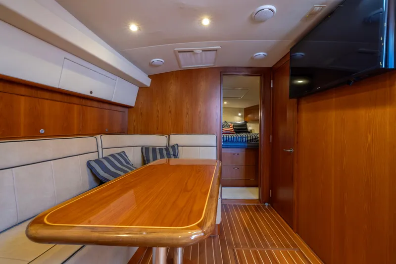 Slide: The Image of Luxurious interior of 2012 Cabo 44 Hardtop Express yacht with cozy seating and wooden finishes. - 82