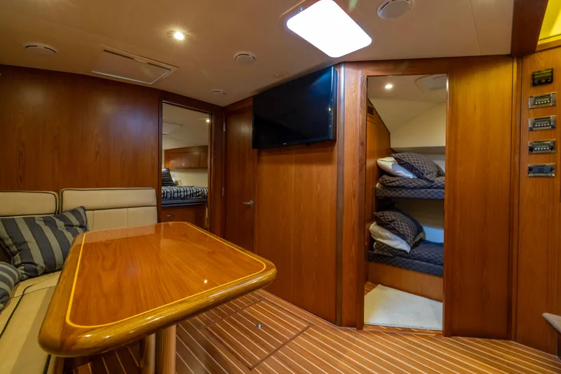 Slide: The Image of Luxurious interior of 2012 Cabo 44 Hardtop Express yacht with wood finishes and seating area. - 83