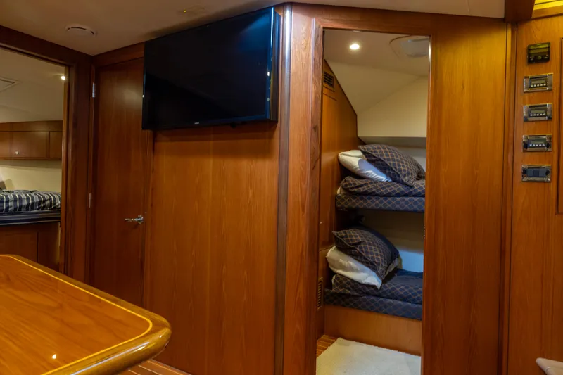 Slide: The Image of Luxurious interior of 2012 Cabo 44 Hardtop Express yacht with wood finish and cozy seating. - 84