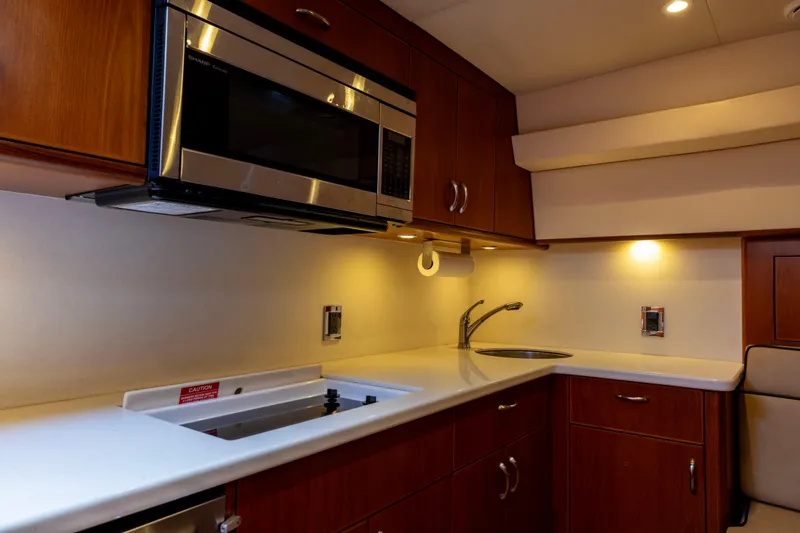Slide: The Image of Luxurious kitchen interior of 2012 Cabo 44 Hardtop Express yacht with modern appliances. - 92