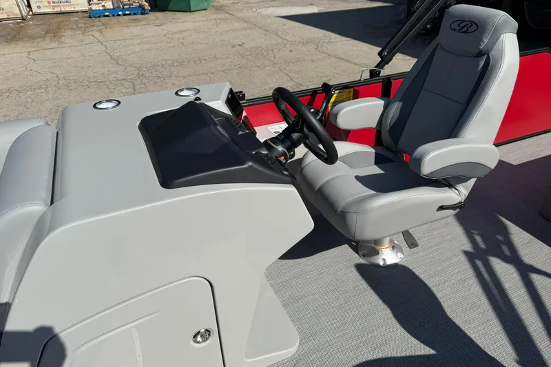 Slide: The Image of 2025 Bentley Pontoons Legacy 243 Swingback helm with gray captain's chair and steering wheel. - 5
