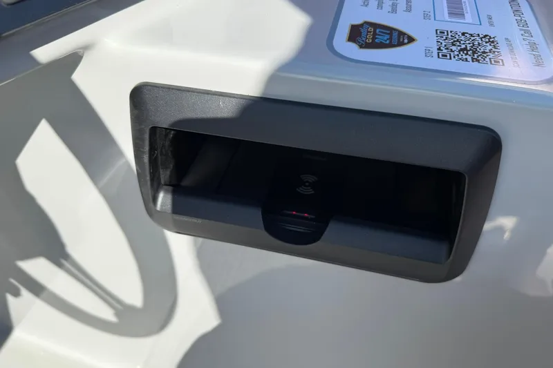 Slide: The Image of 2025 Bentley Pontoons Legacy 243 Swingback dashboard with wireless charging dock and QR code. - 8
