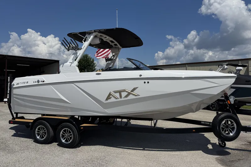 The Image of 2026 ATX Surf Boats 22 Type-S on trailer, sleek design under blue sky. - 1
