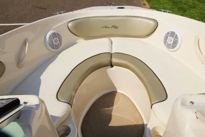 Slide: The Image of 2006 Sea Ray 205 Sport boat interior with cushioned seating and speakers. - 5