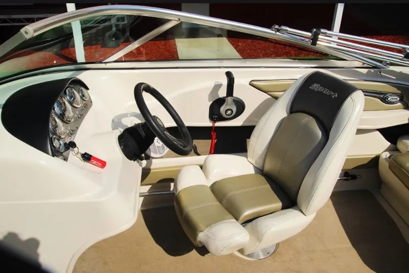 Slide: The Image of Interior of a 2006 Sea Ray 205 Sport boat, featuring steering wheel and dashboard. - 8