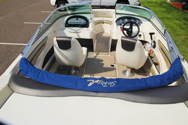 Slide: The Image of 2006 Sea Ray 205 Sport boat interior with steering wheel and seating. - 9