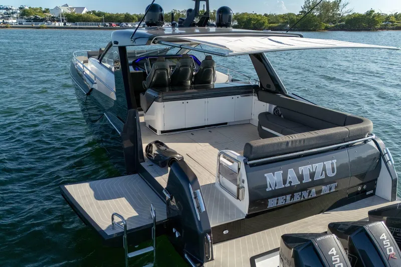 Slide: The Image of 2023 Azimut Verve 47 luxury yacht on water, rear view with seating and engines. - 15