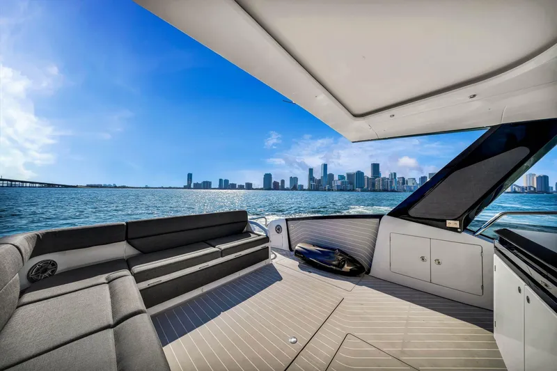 Slide: The Image of 2023 Azimut Verve 47 yacht interior with city skyline view, luxurious seating, and modern design. - 25