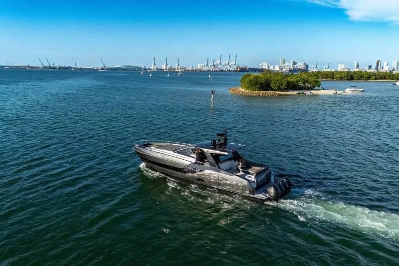 Slide: The Image of 2023 Azimut Verve 47 yacht cruising near a city skyline and small island. - 41