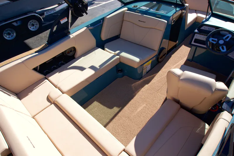 Slide: The Image of 2025 MasterCraft NXT20 boat interior with beige seating and modern dashboard. - 9