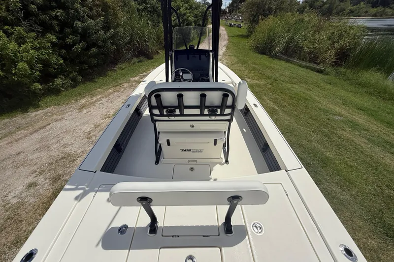 Slide: The Image of 2026 Pathfinder 2300 HPS boat on grassy path, showcasing seating and console. - 12