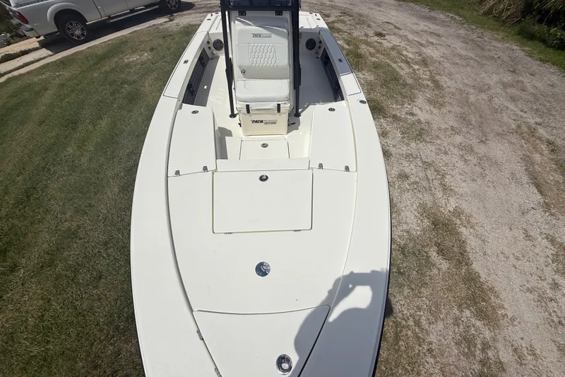 Slide: The Image of 2026 Pathfinder 2300 HPS boat on grass, showcasing deck and seating area. - 18