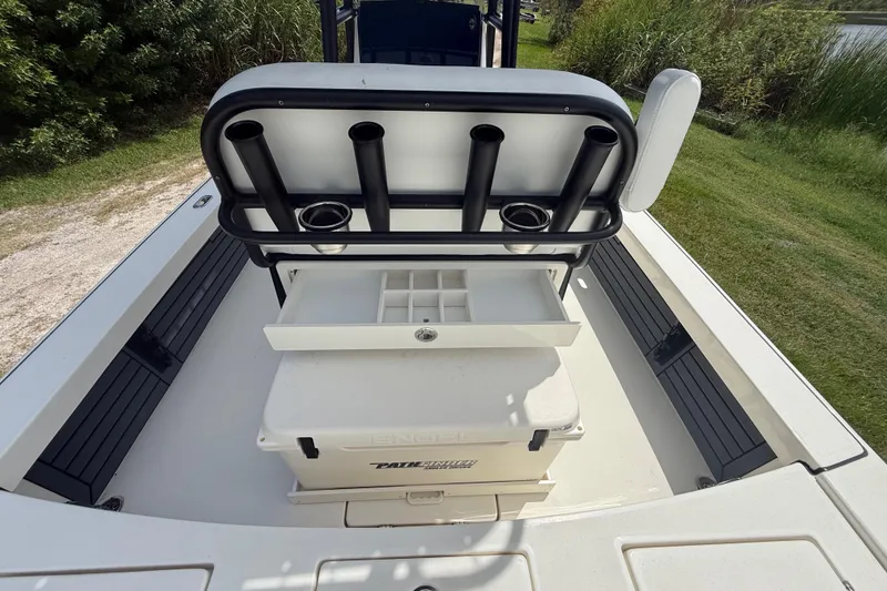 Slide: The Image of 2026 Pathfinder 2300 HPS boat interior with rod holders and storage compartments. - 28
