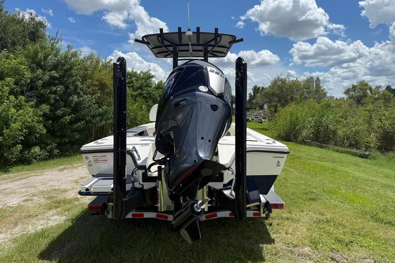 Slide: The Image of 2026 Pathfinder 2300 HPS boat on trailer, surrounded by lush greenery and blue sky. - 3