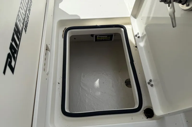 Slide: The Image of Open storage compartment on 2026 Pathfinder 2300 HPS boat with Power Bubbles air pump. - 30