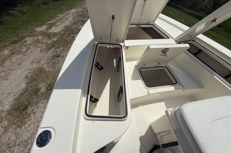 Slide: The Image of 2026 Pathfinder 2300 HPS boat storage compartments open, showcasing interior space. - 34