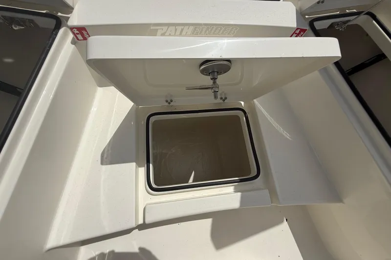 Slide: The Image of 2026 Pathfinder 2300 HPS boat storage compartment with open lid and latch. - 35