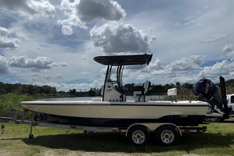 Slide: The Image of 2026 Pathfinder 2300 HPS boat on trailer under cloudy sky. - 8