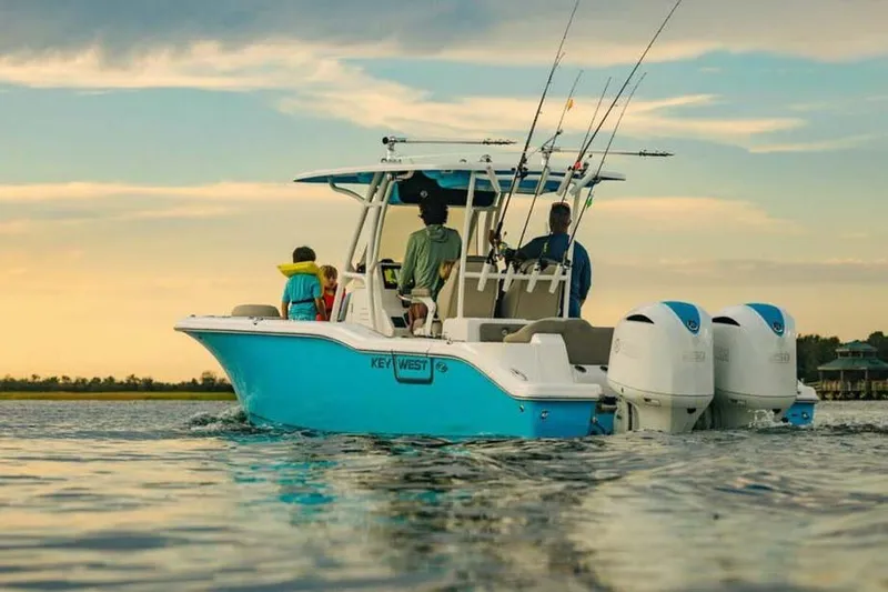 The Image of 2026 Key West 263 FS boat on water at sunset, equipped for fishing. - 1