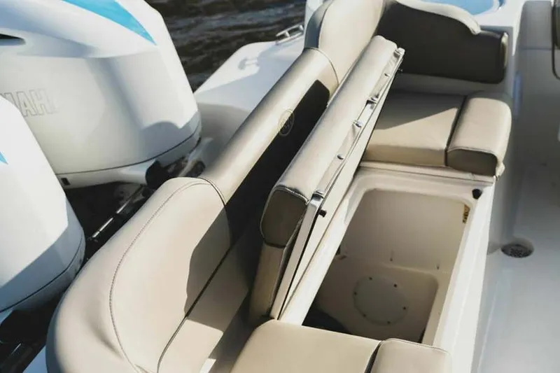 Slide: The Image of 2026 Key West 263 FS boat with beige seating and storage compartment. - 10