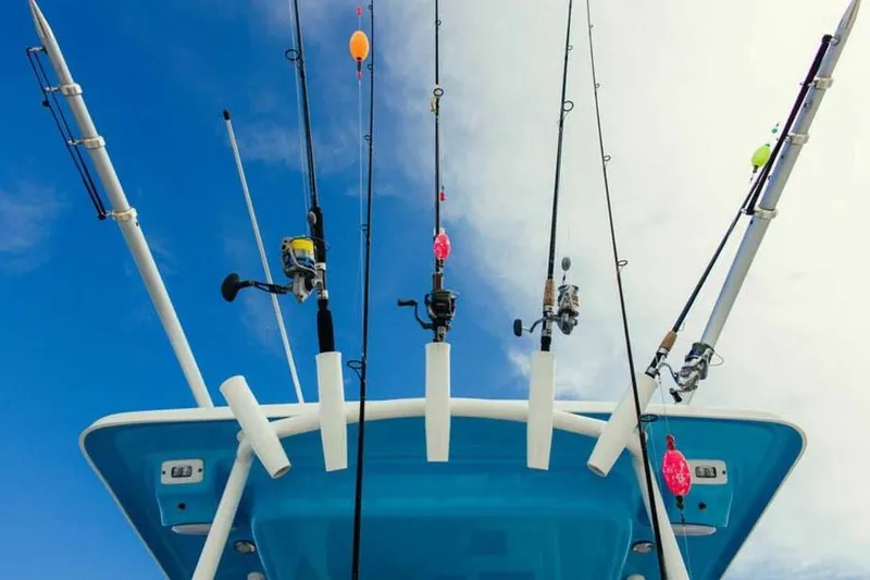 Slide: The Image of Fishing rods on a 2026 Key West 263 FS boat against a blue sky. - 3