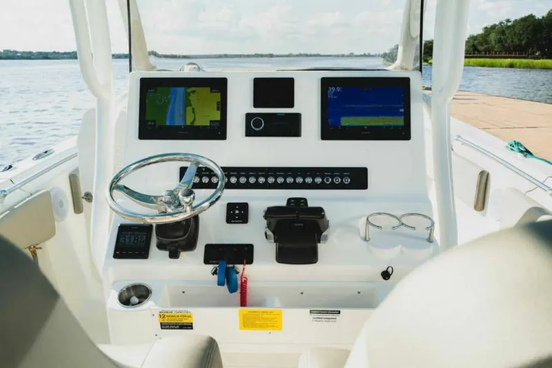 Slide: The Image of 2026 Key West 263 FS boat dashboard with navigation screens and controls. - 4