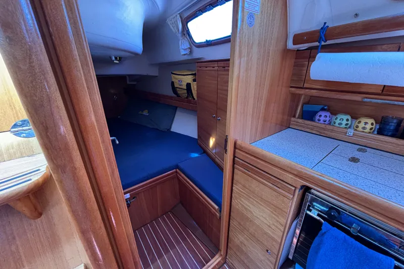 Slide: The Image of Interior of 2007 Bavaria Cruiser 33 sailboat with cozy cabin and wooden finishes. - 14