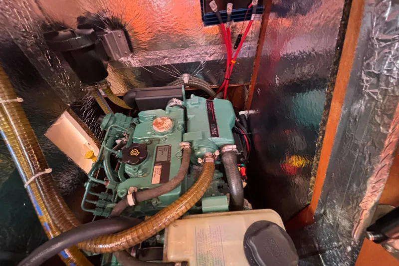 Slide: The Image of Engine compartment of a 2007 Bavaria Cruiser 33 sailboat, featuring a compact marine engine. - 17