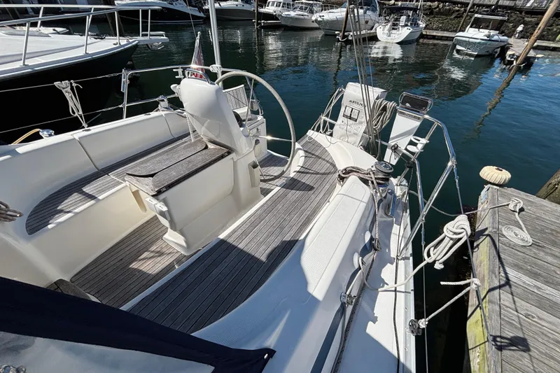 Slide: The Image of 2007 Bavaria Cruiser 33 sailboat docked, featuring spacious cockpit and elegant design. - 18