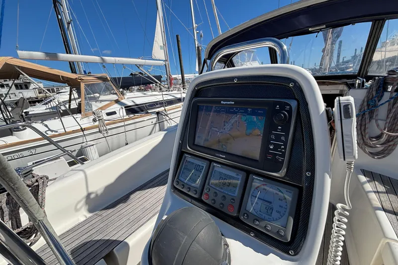 Slide: The Image of Cockpit of 2007 Bavaria Cruiser 33 with navigation instruments and marina view. - 19