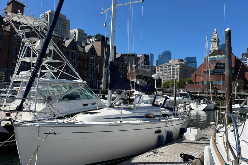 Slide: The Image of 2007 Bavaria Cruiser 33 yacht docked in urban marina with cityscape background. - 23