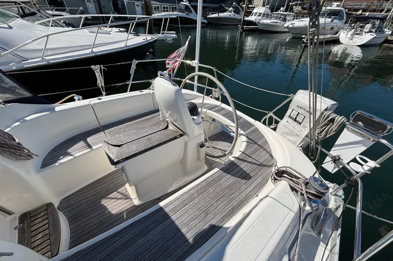 Slide: The Image of 2007 Bavaria Cruiser 33 sailboat cockpit with wooden seating and steering wheel. - 26