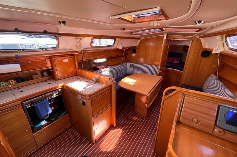 Slide: The Image of Interior of 2007 Bavaria Cruiser 33 yacht with wooden finish and striped seating. - 29