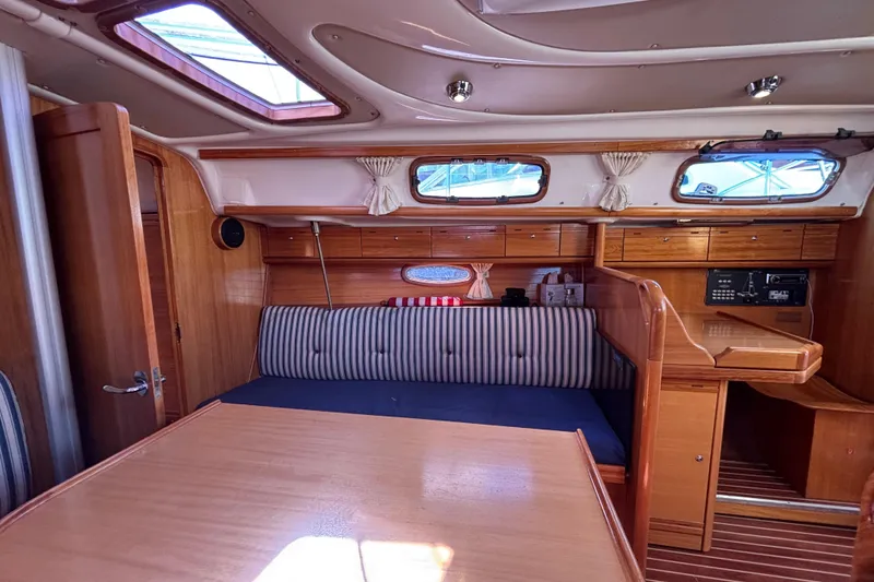 Slide: The Image of Interior of 2007 Bavaria Cruiser 33 sailboat with wood finish and striped seating. - 35