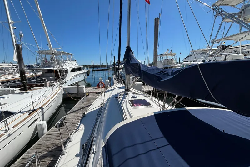 Slide: The Image of 2007 Bavaria Cruiser 33 sailboat docked at marina under clear blue sky. - 37