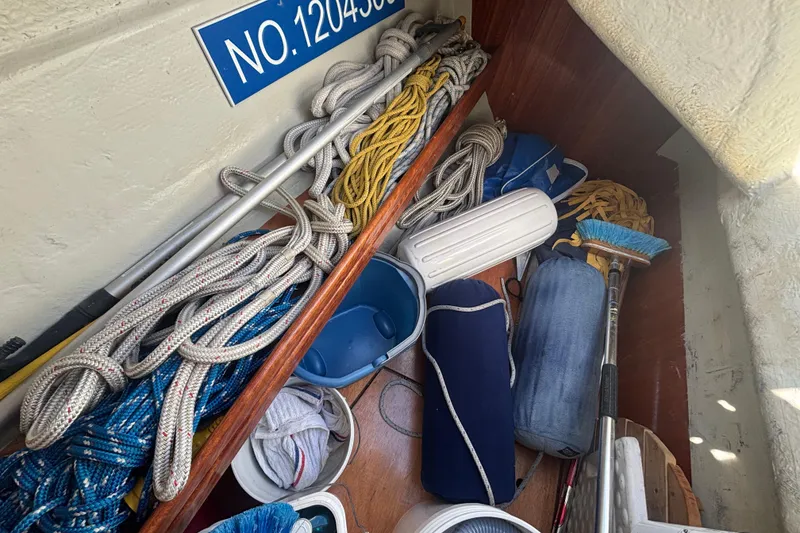 Slide: The Image of Storage area on a 2007 Bavaria Cruiser 33 with ropes and cleaning tools. - 38