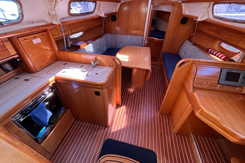 Slide: The Image of Interior of 2007 Bavaria Cruiser 33 sailboat with wood finish and cozy seating. - 5