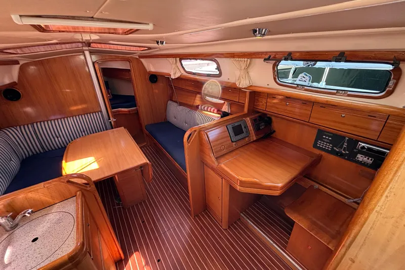 Slide: The Image of Interior of 2007 Bavaria Cruiser 33 sailboat with wood finish and seating area. - 6