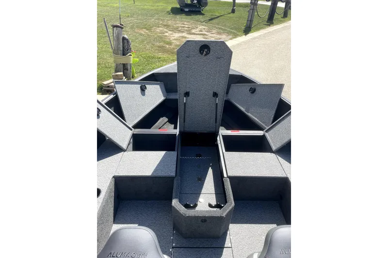 Slide: The Image of 2026 Alumacraft Voyageur 175 Tiller boat interior with gray seating and deck. - 4