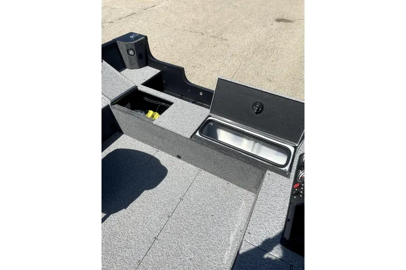 Slide: The Image of 2026 Alumacraft Voyageur 175 Tiller boat interior with storage compartment and seating. - 6