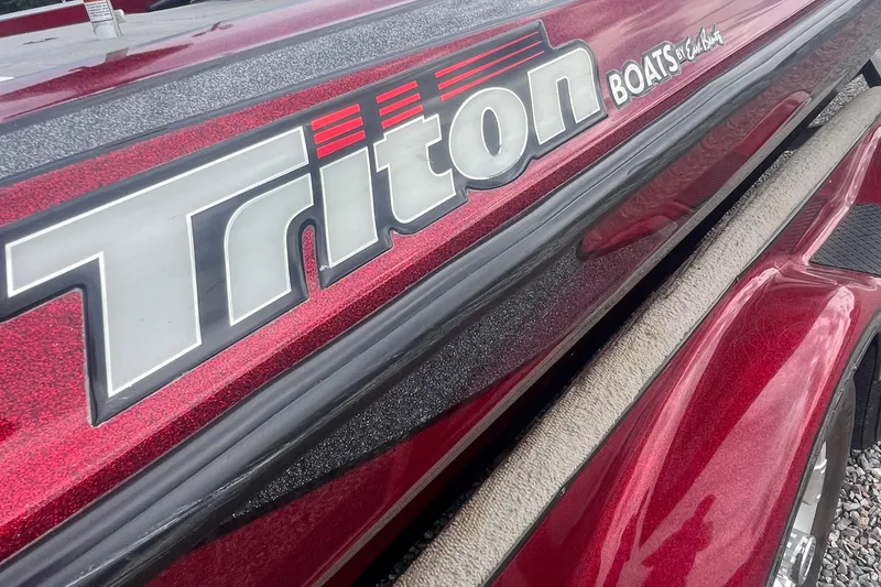 Slide: The Image of Close-up of 2009 Triton 21X3 Pro DC boat logo on red exterior. - 10