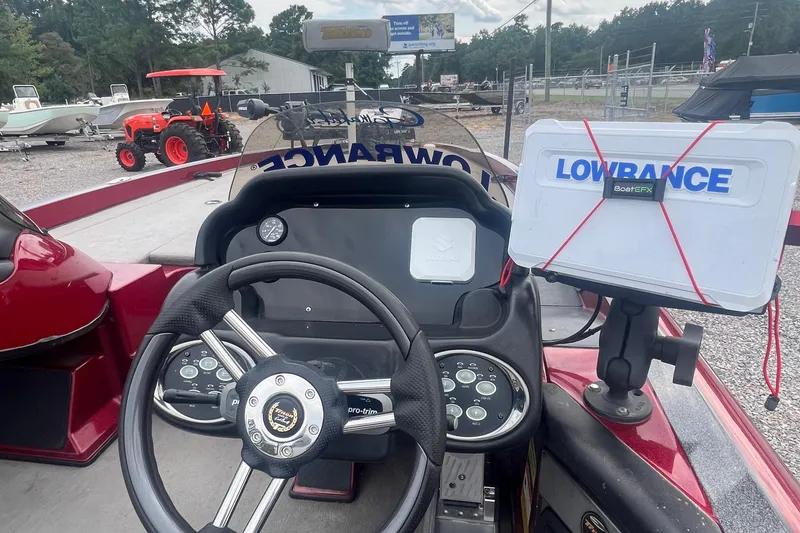Slide: The Image of 2009 Triton 21X3 Pro DC boat dashboard with Lowrance GPS and steering wheel. - 12